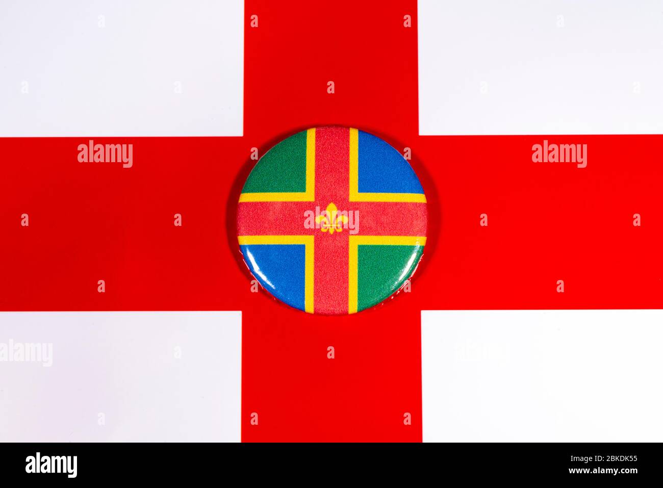 A badge portraying the flag of the English county of Lincolnshire, pictured over the England flag. Stock Photo