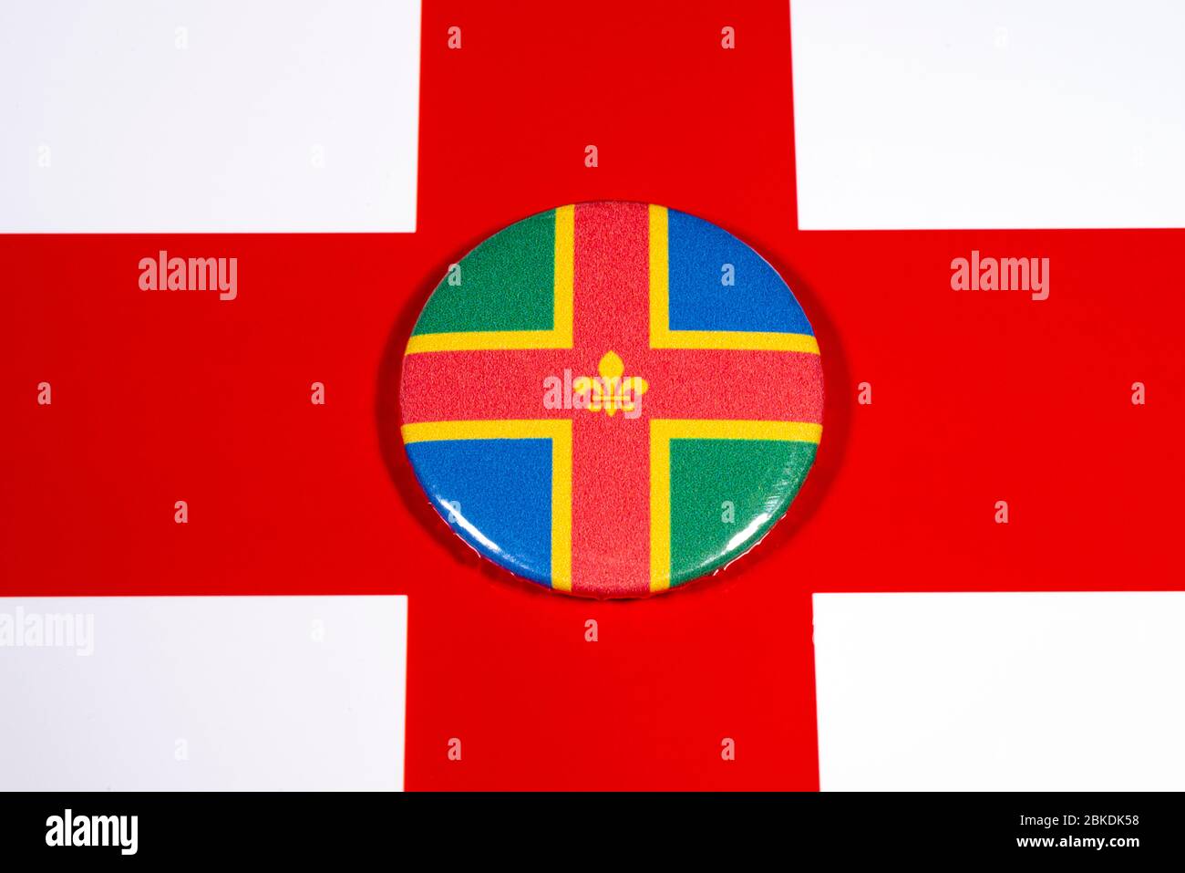 A badge portraying the flag of the English county of Lincolnshire, pictured over the England flag. Stock Photo