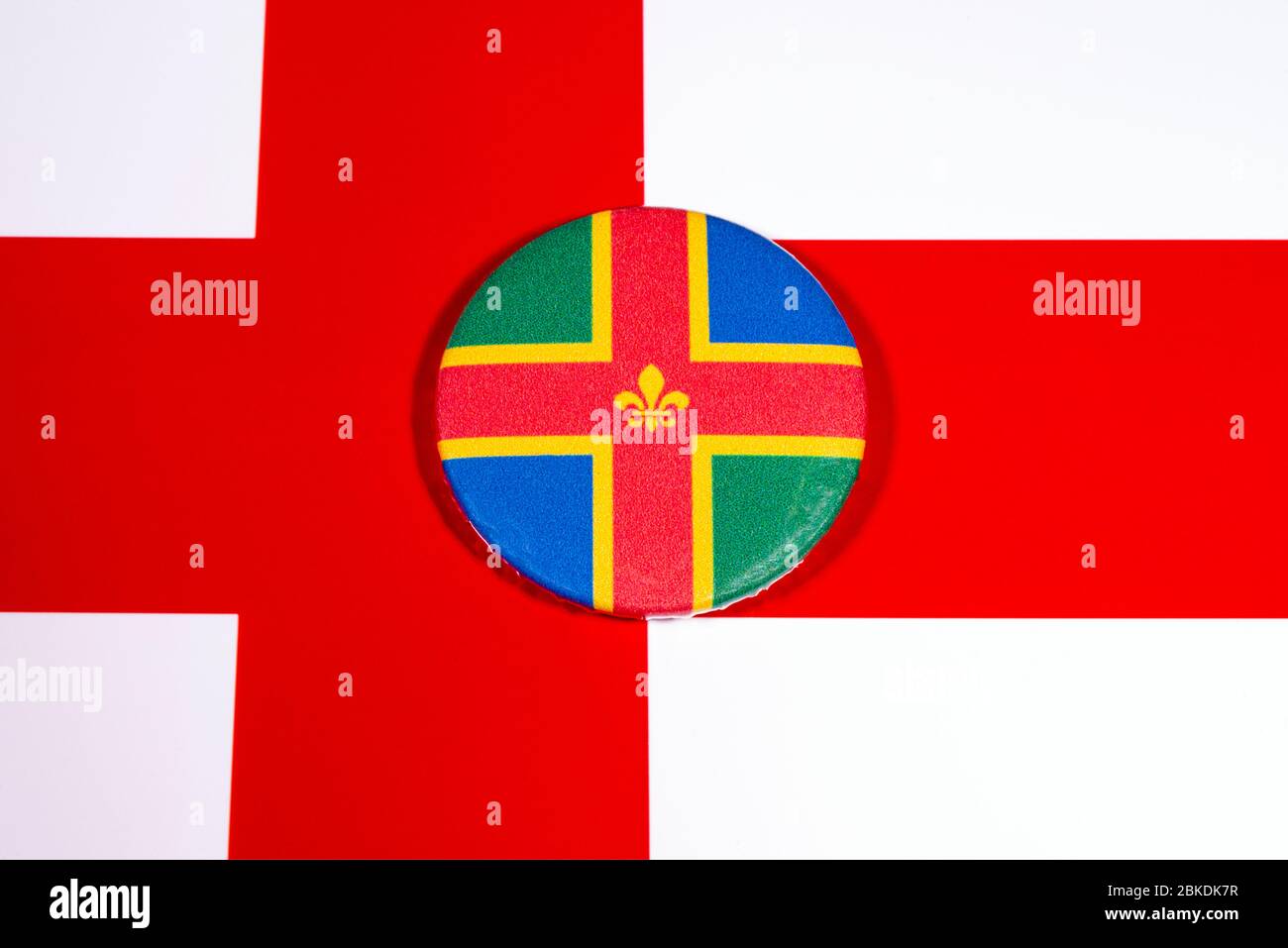 A badge portraying the flag of the English county of Lincolnshire, pictured over the England flag. Stock Photo