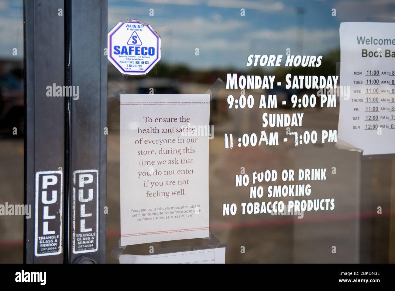 Lake Jackson, United States. 03rd May, 2020. A sign on the front door of the Boot Barn clothing store in Lake Jackson, Texas lets customers know that they shouldn't enter if they aren't feeling well on Sunday, May 3, 2020. Retail stores in Texas were allowed to reopen for customers at reduced capacity starting on May 1st as the state began easing restrictions based on COVID-19. Photo by Trask Smith/UPI Credit: UPI/Alamy Live News Stock Photo