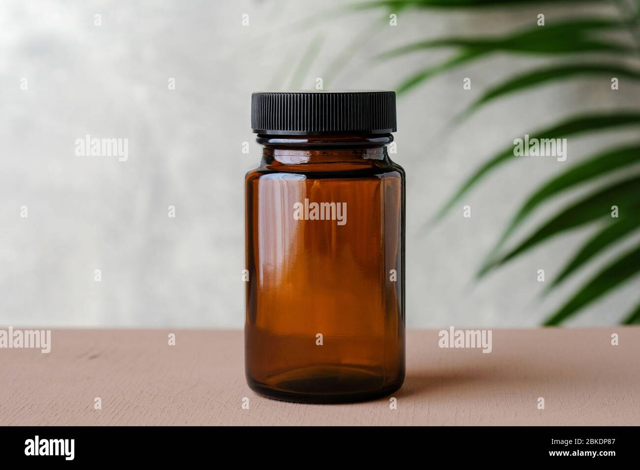 Download Blank Medical Bottle Mockup For Pills Transparent Dark Bottle Of Amber Glass With Green Plant Herbal Medicine Concept Stock Photo Alamy