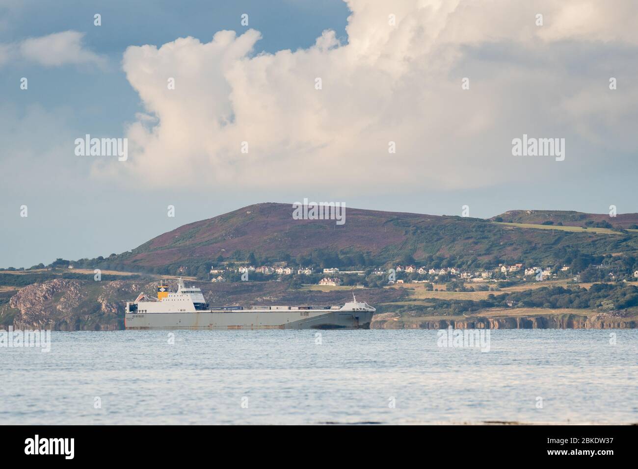 Ro-ro cargo ship named 'Vespertine' sailing past Howth head after departing Dublin port in Ireland Stock Photo