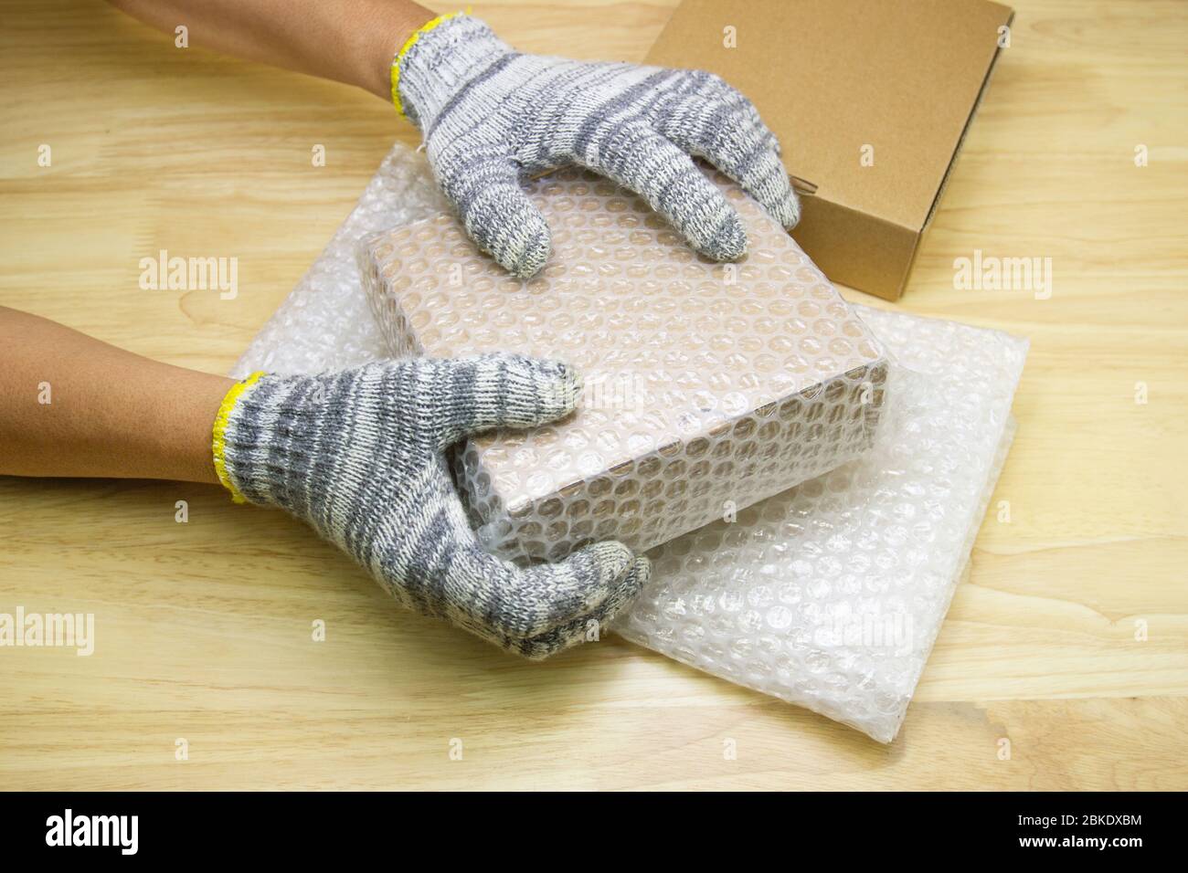 hand of man hold bubble wrap for protection parcel product