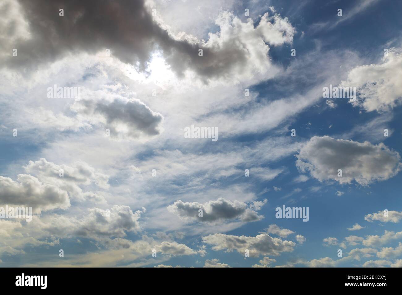 Blue sky background with white fluffy clouds close up Stock Photo - Alamy
