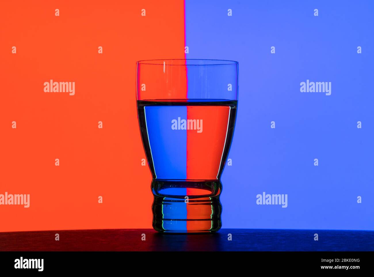https://c8.alamy.com/comp/2BKE0NG/glass-of-water-against-a-two-color-background-water-in-refracting-light-still-life-2BKE0NG.jpg