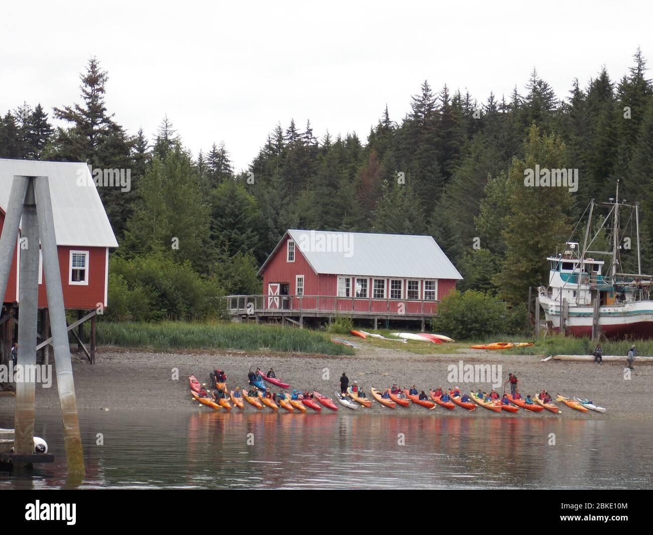 Kayaks lined up along the shore in Icy Strait Point (Hoonah), Alaska for cruise passengers on excursions. Stock Photo