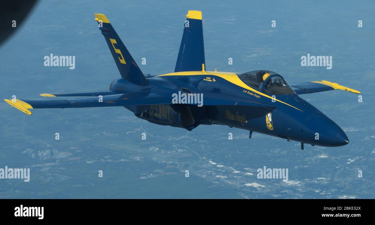 An F/A-18 Hornet assigned to the U.S. Navy Blue Angels flys over Washington DC, Baltimore and Atlanta during an America Strong flyover, May 2, 2020. The demonstration team conducted the flyovers alongside the U.S. Air Force Thunderbirds to honor healthcare workers, first responders, and other essential personnel who are working on the front lines to combat COVID-19. (U.S. Air Force photo by Senior Airman Ariel Owings) Stock Photo