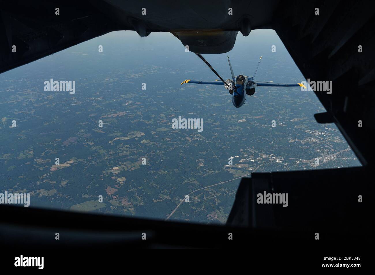 An F/A-18 Hornet assigned to the U.S. Navy Blue Angels refuels in-flight from a 305th Air Mobility Wing KC-10 Extender assigned to Joint Base McGuire-Dix-Lakehurst, N.J., during a flyover as part of the America Strong campaign over Atlanta, Washington DC, and Baltimore, May 2, 2020. The Blue Angels flew alongside the U.S. Air Force Thunderbirds for the campaign to honor healthcare workers, first responders, and other essential peronnel who are working on the front lines to combat COVID-19. (U.S. Air Force photo by Senior Airman Ariel Owings) Stock Photo