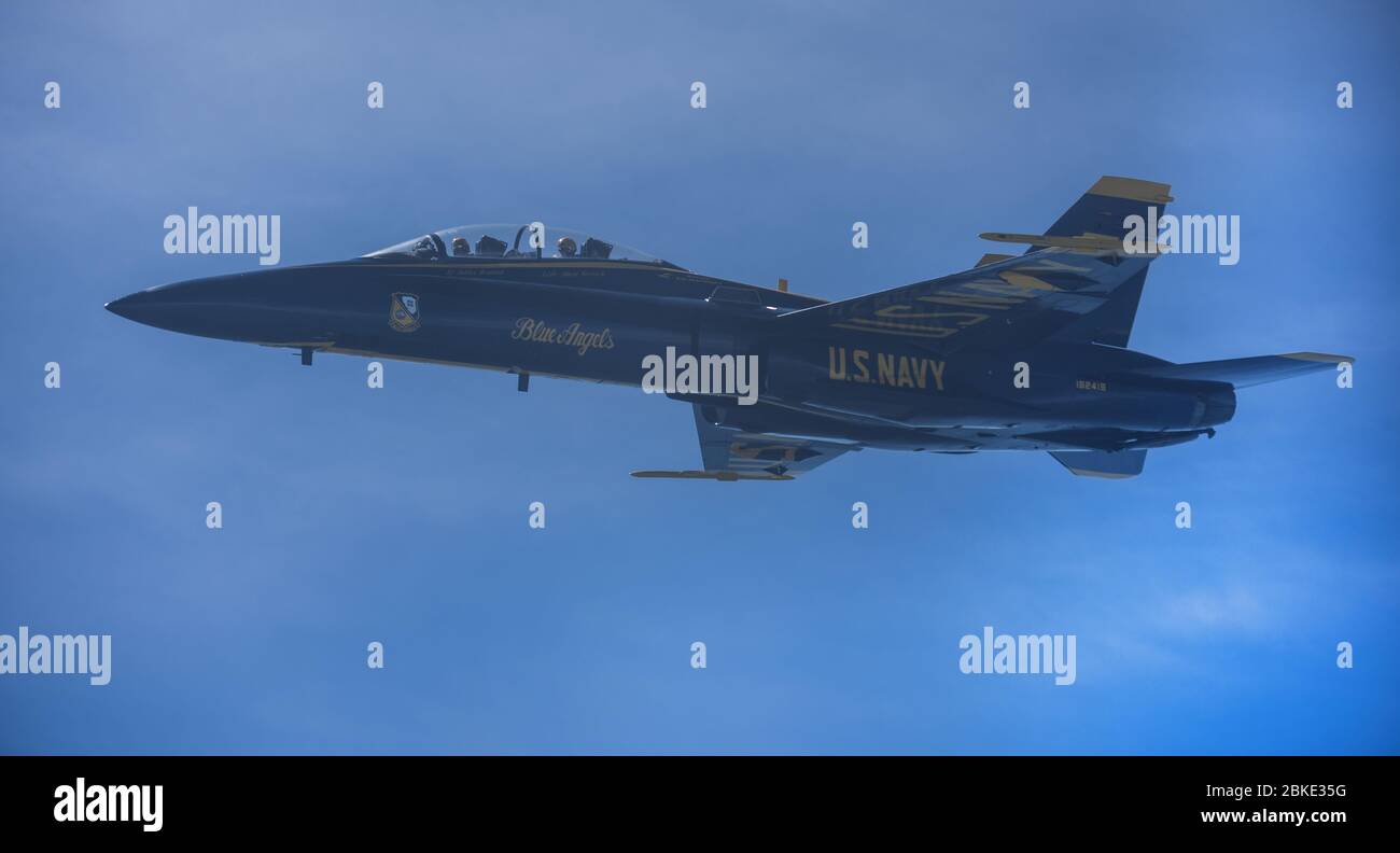 An F/A-18 Hornet assigned to the U.S. Navy Blue Angels flys over Washington DC, Baltimore and Atlanta during an America Strong campaign, May 2, 2020. The demonstration team conducted flyovers alongside the U.S. Air Force Thunderbirds to honor healthcare workers, first responders, and other essential personnel who are working on the front lines to combat COVID-19. (U.S. Air Force photo by Senior Airman Ariel Owings) Stock Photo