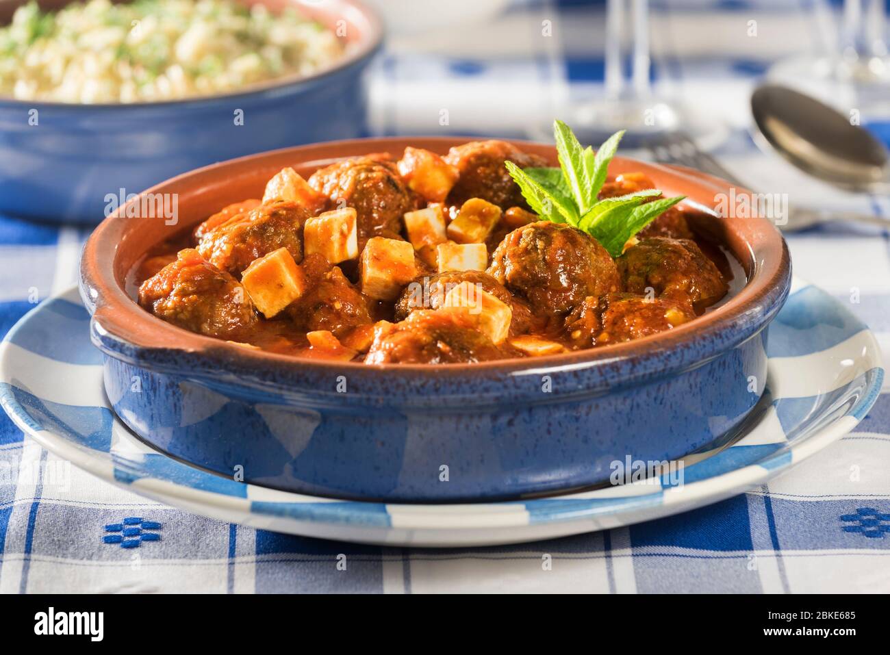 Keftedes saganaki with orzo. Meatballs in tomato and feta sauce. Greece Food Stock Photo