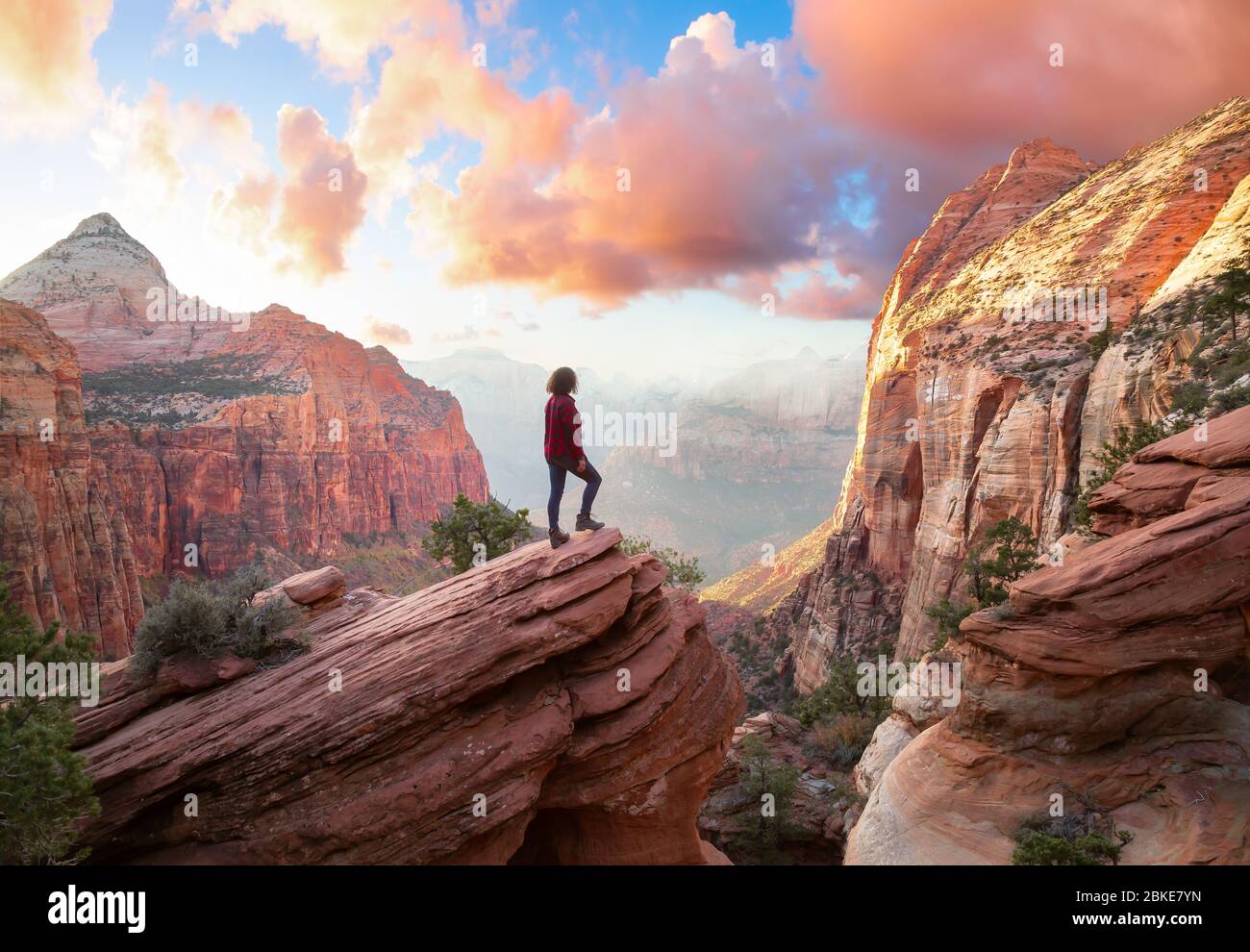 Adventurous Woman at the edge of a cliff is looking at a beautiful landscape view in the Canyon Stock Photo Alamy