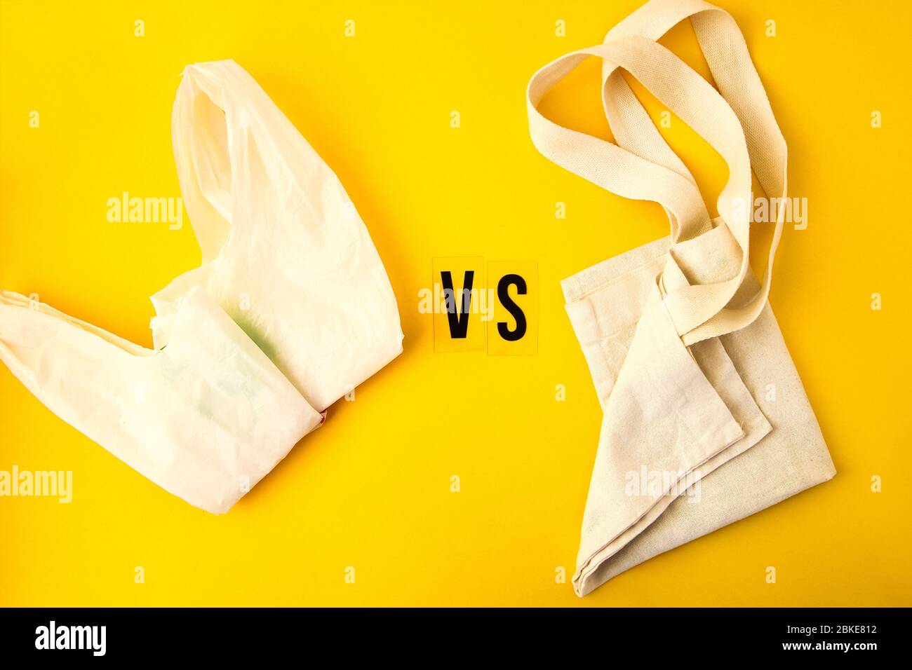 Clear disposable plastic bag on yellow background vs eco tote bags