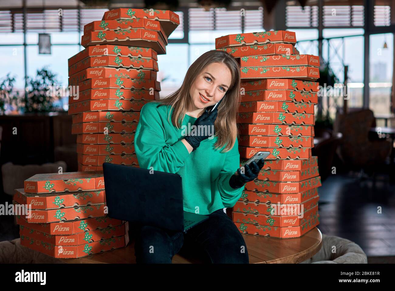 delivery girl is covered in pizza boxes Stock Photo - Alamy