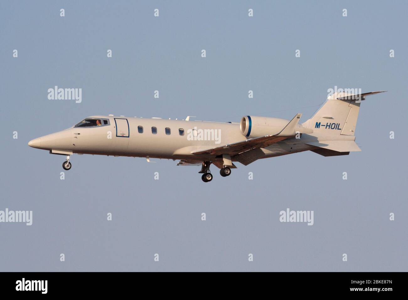 Bombardier Learjet 60 business jet airplane flying on approach. Side view. Executive air travel. Stock Photo