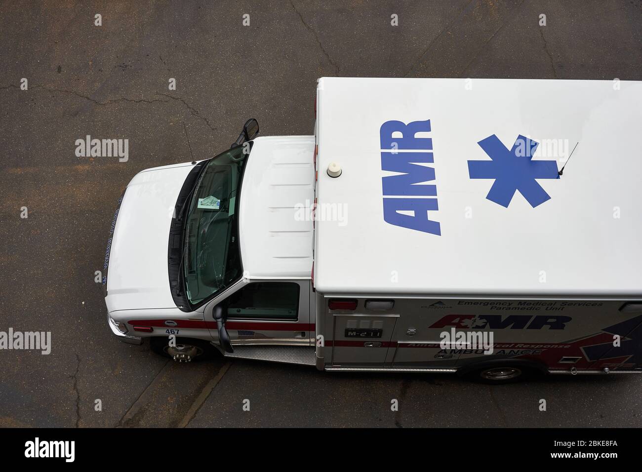 An American Medical Response (AMR) ambulance responding to emergency is seen parked on the neighborhood street in Lake Oswego, Oregon. Stock Photo