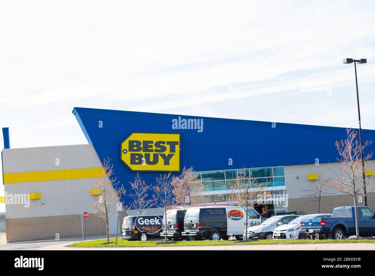Best Buy storefront seen with the Geek Squad vehicles parked in the parking lot. Since covid19 pandemic most stores are closed. Stock Photo