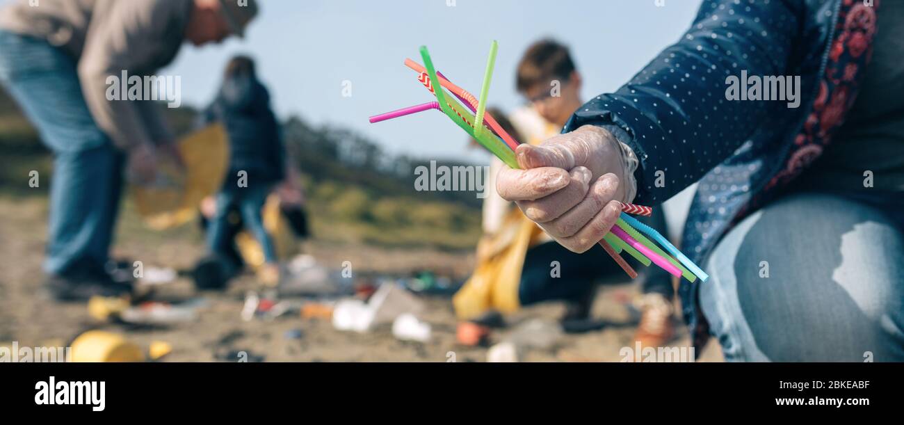 Woman showing handful of straws collected on the beach Stock Photo