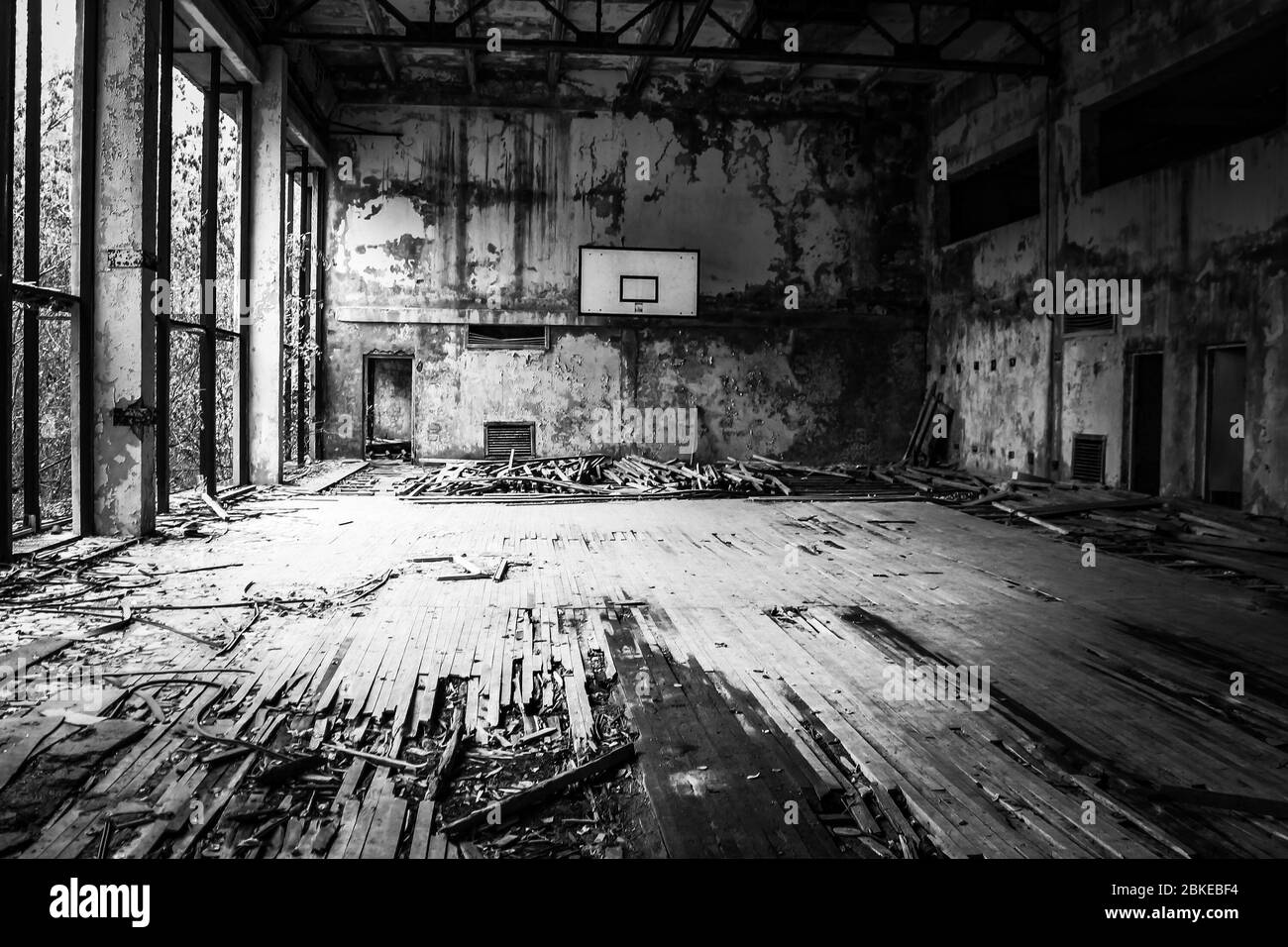 Black and white decaying basketball court in Pripyat, Ukraine, abandoned city after the 1986 Chernobyl nuclear desaster. Stock Photo