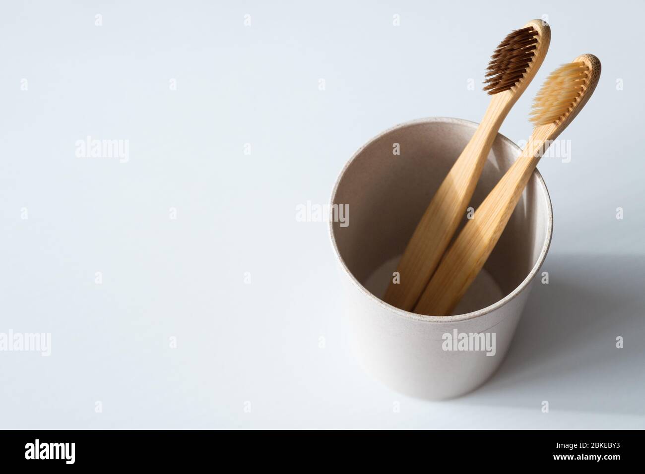 Eco friendly natural bamboo toothbrushes in glass on white background ...