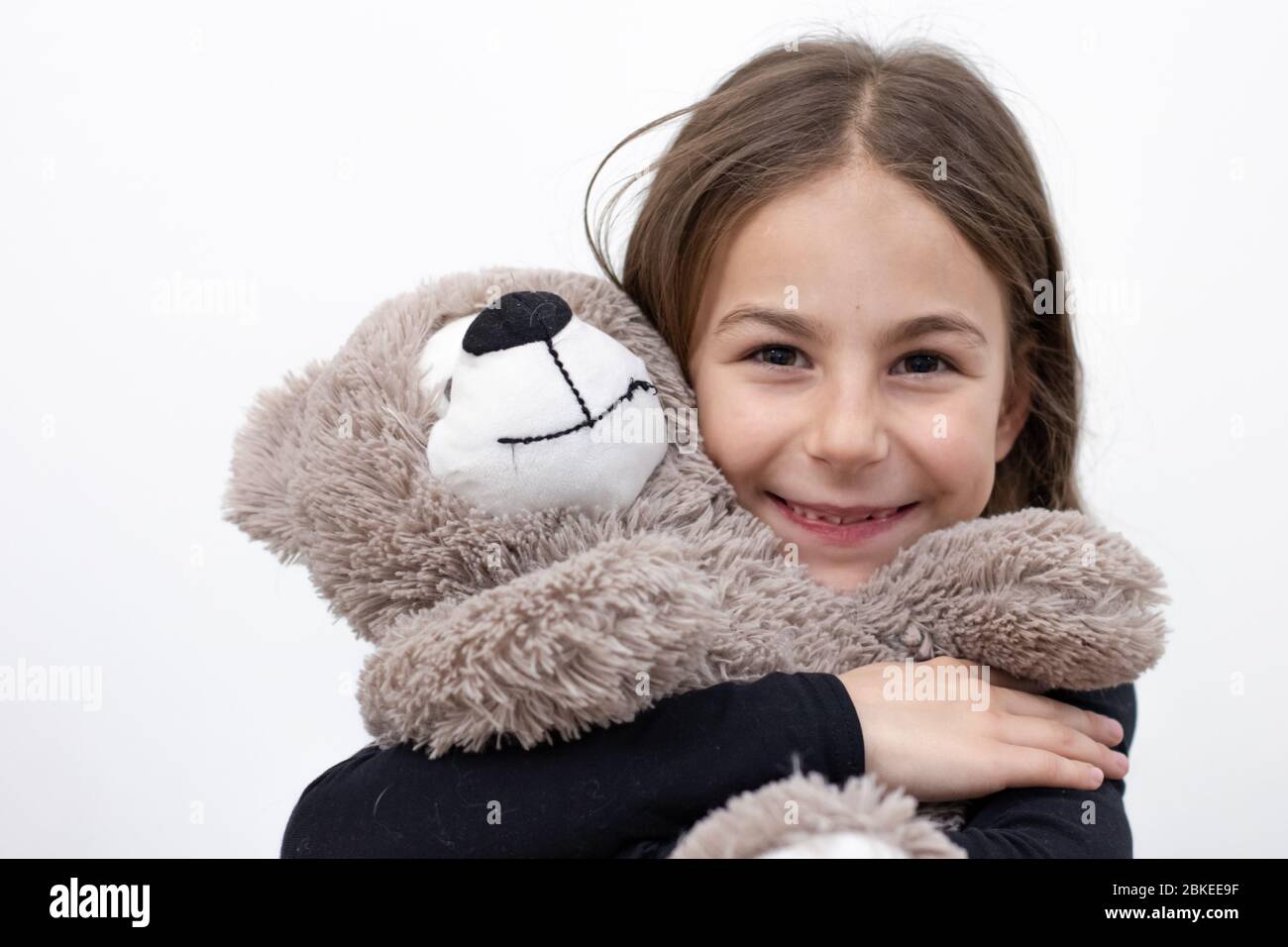 Happy baby girl with big gray teddy bear close-up Stock Photo - Alamy
