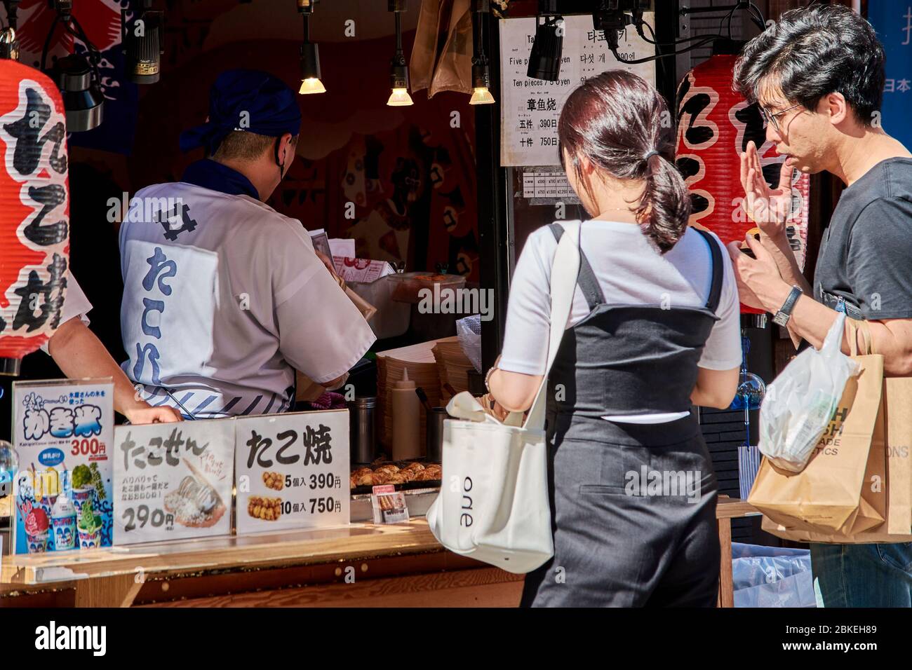 Osaka / Japan - May 21, 2018: Street food vendor selling Takosen, sandwiches made up of two Senbei rice crackers filled with Takoyaki octopus balls, D Stock Photo