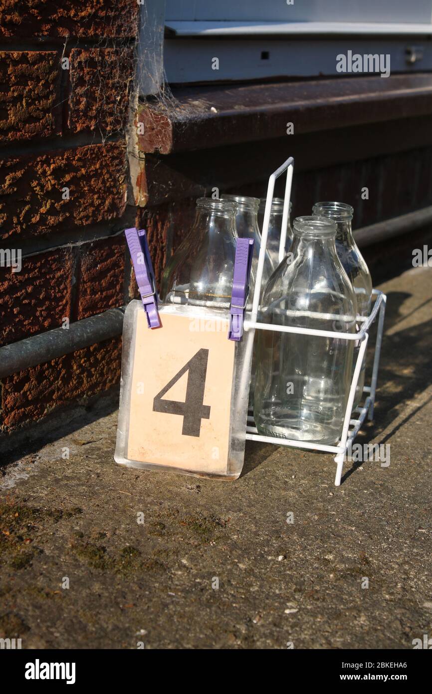 Milk crate on driveway by front door of a house waiting for doorstep