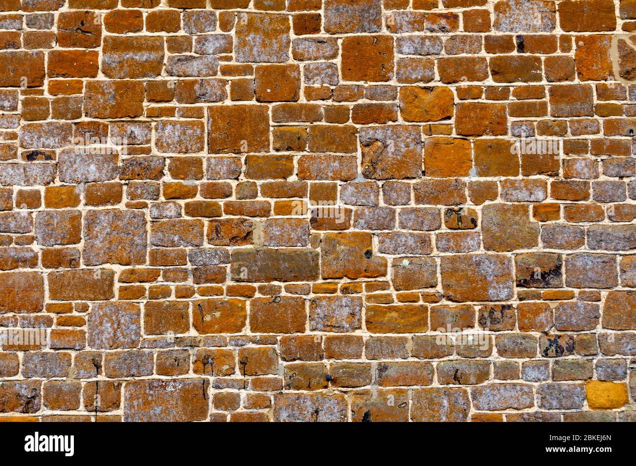 Cut blocks of carstone or carrstone used as a building material in the side of a Norfolk cottage. Stock Photo