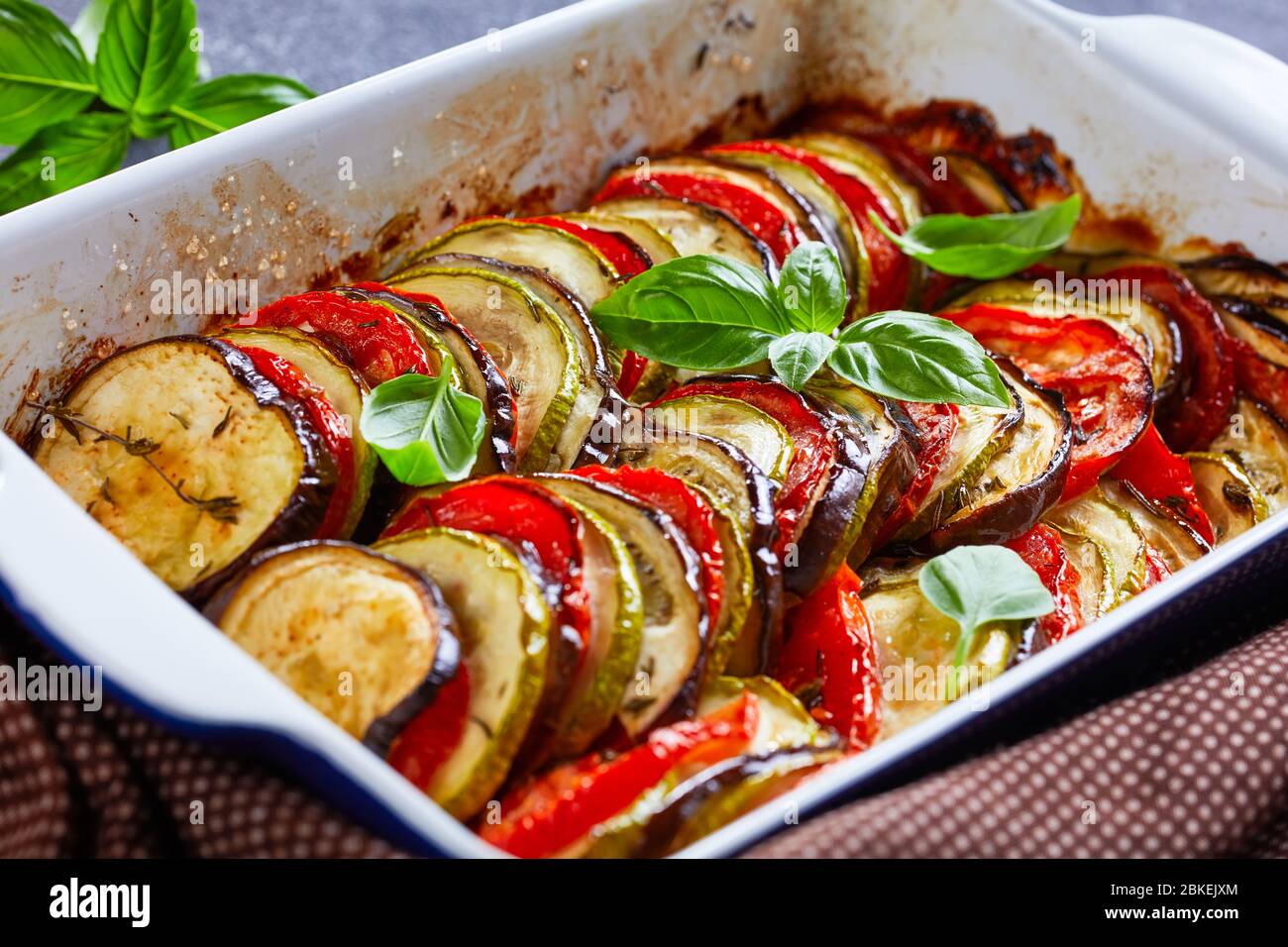 french tian provencal, baked sliced layered vegetables in a baking dish