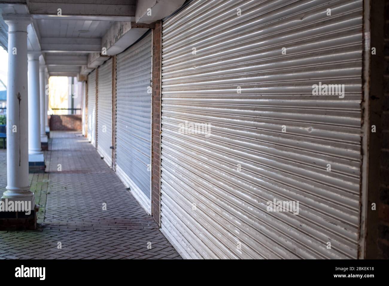 Closed and shuttered shop fronts, metal shutters down Stock Photo - Alamy