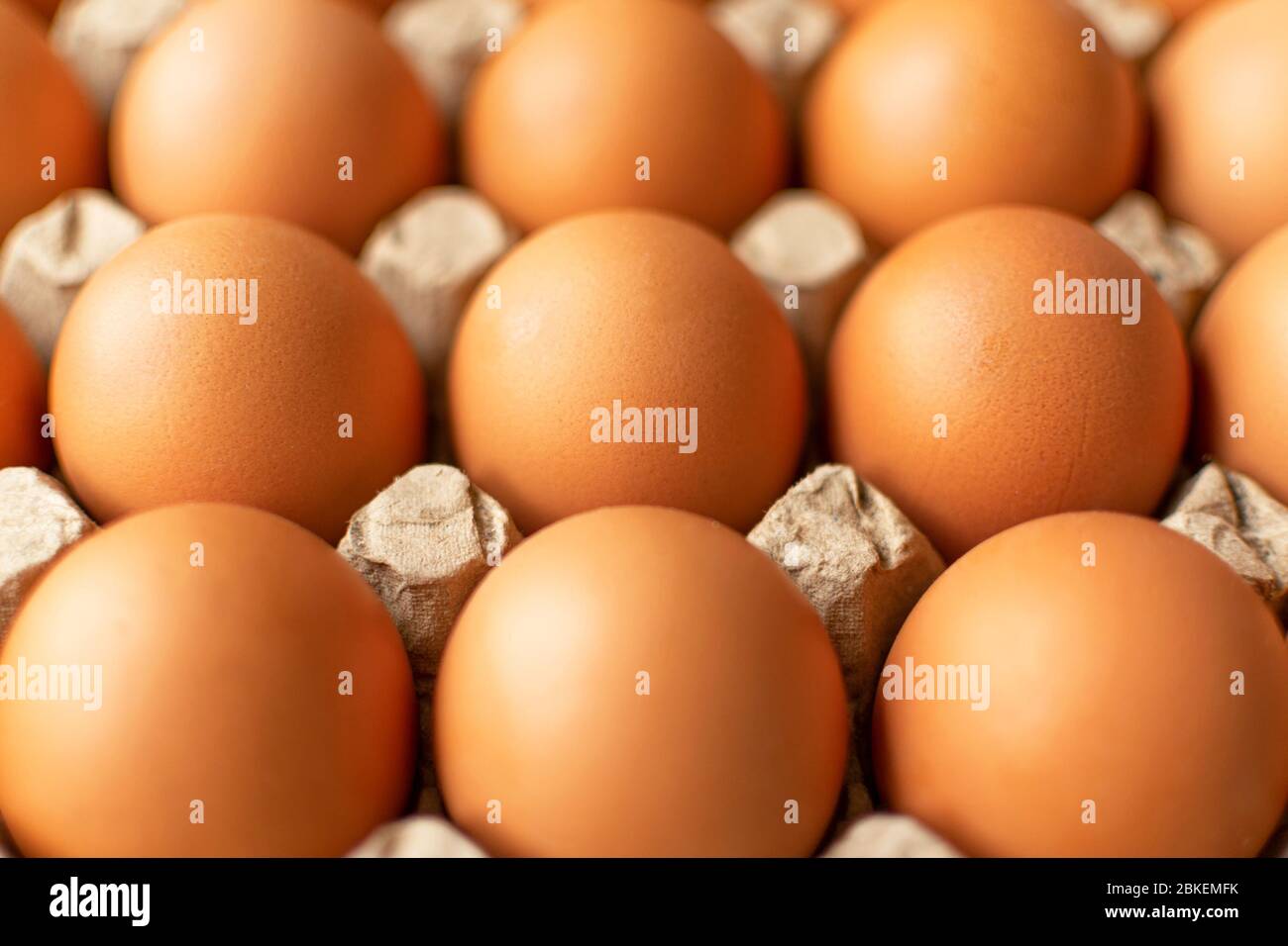 Brown egg in paper packaging. Container for eggs. Recycling. Healthy rustic breakfast Stock Photo