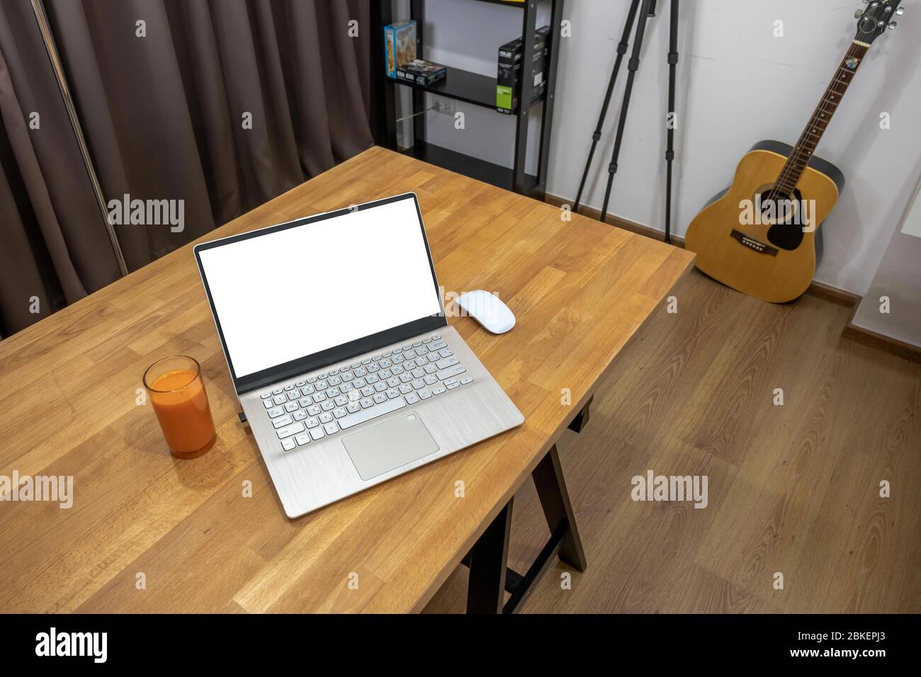 Remotely working at home office in your room.A laptop computer with copy space  on the table.You can create your workplace at your house. Stock Photo