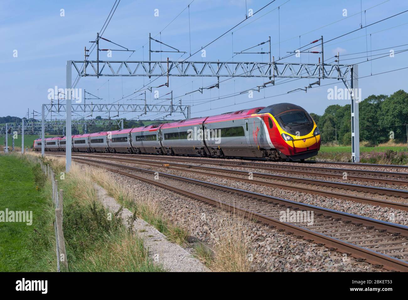 Virgin trains class 390 Alstom Pendolino 390049 passing Stableford, Staffordshire on the 4 track west coast mainline Stock Photo