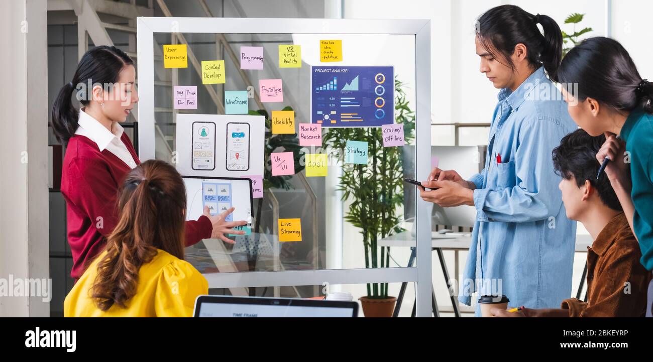 ux developer and ui designer presenting  and testing mobile app interface design on whiteboard in meeting at modern office.Creative digital developmen Stock Photo