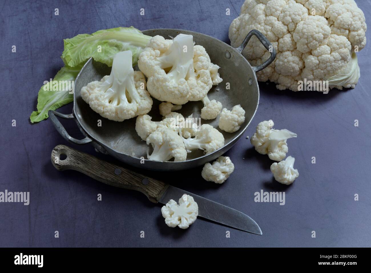 Cauliflower in bowl and kitchen knife, food photography, studio shot, Germany Stock Photo