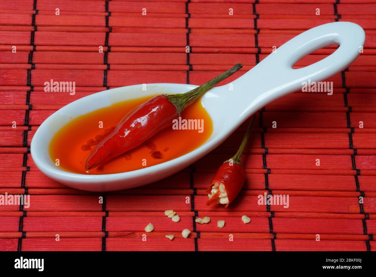 Chilli oil and chilli pepper in ceramic bowls, food photography, studio shot, Germany Stock Photo