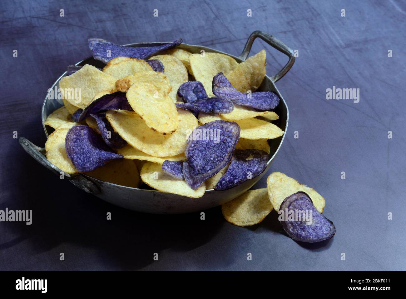 Different coloured potato chips in skin, food photography, studio shot, Germany Stock Photo