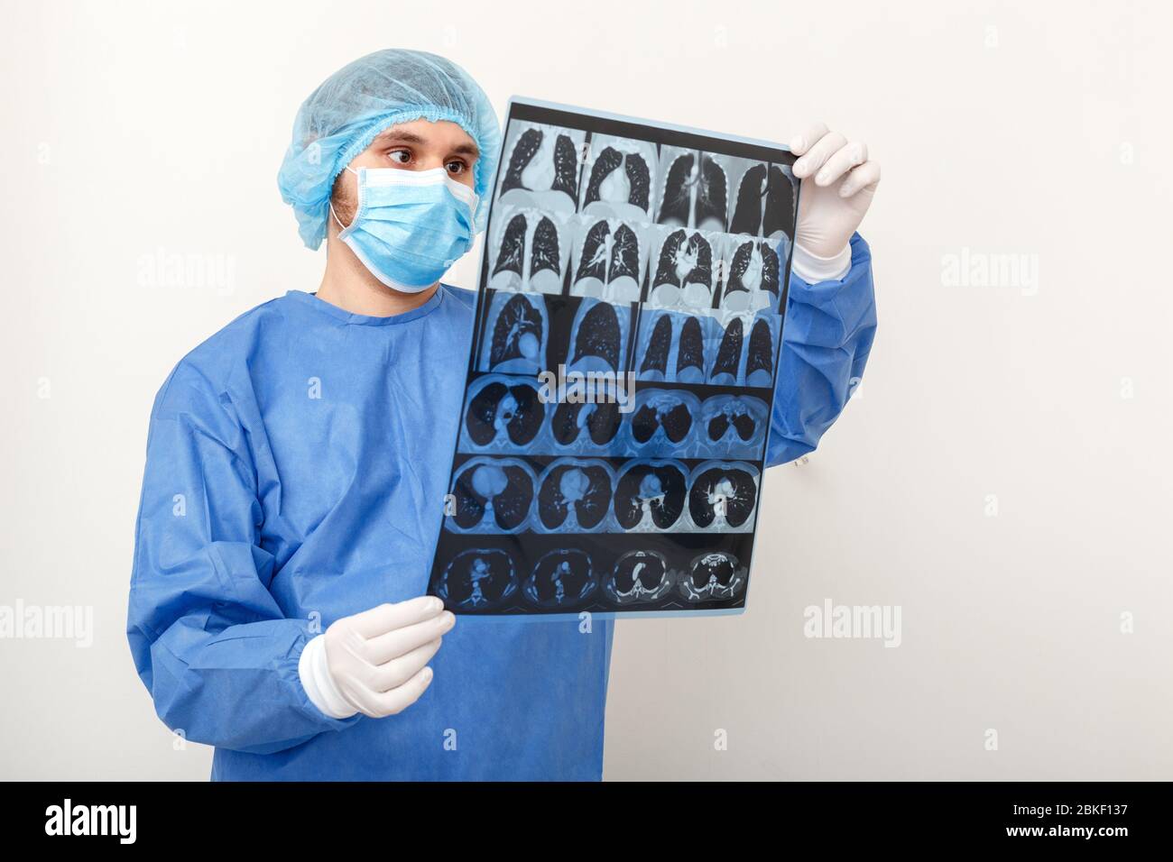 Lungs scan in Doctor hands. Surgeon in protective uniform check up MRI film. Coronavirus Covid 19, pneumonia, tuberculosis, lung cancer, respiratory Stock Photo