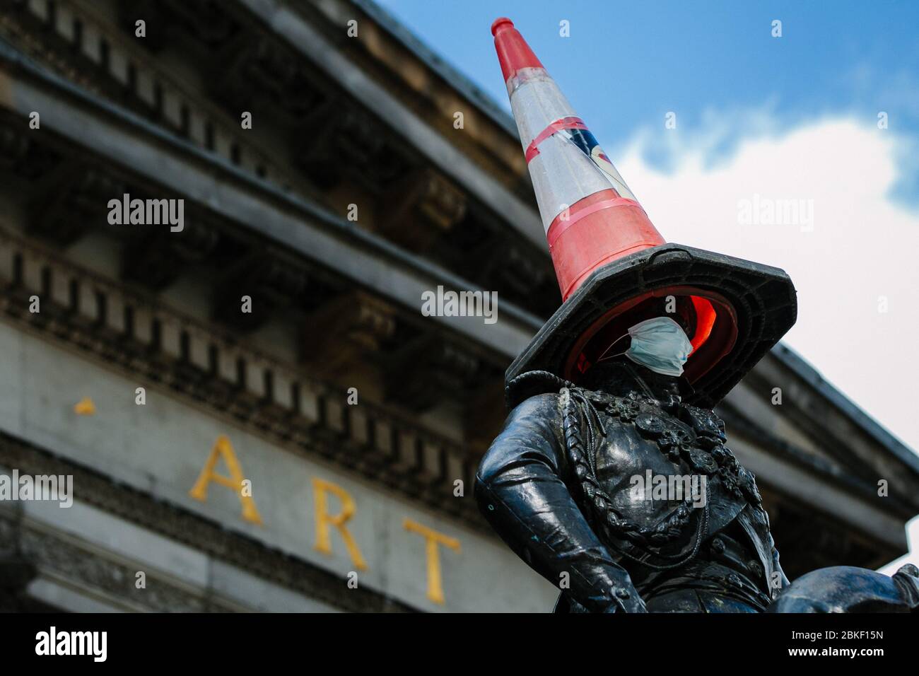 Duke of Wellington statue in Glasgow with traffic cone on head, and Corona Virus face mask. Stock Photo