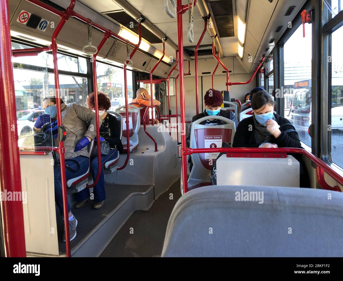 Rom, Italy. 04th May, 2020. Passengers wearing protective masks sit in a bus that runs from Termini Central Station to the Trastevere district. After almost two long months, Italy has relaxed the curfews, which were among the strictest in Europe. Credit: Alvise Armellini/dpa/Alamy Live News Stock Photo