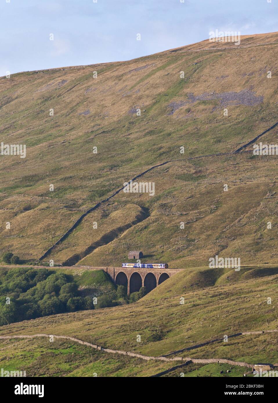 Northern Rail class 158 express sprinter train crossing Arten Gill viaduct in the landscape on the Settle to Carlisle railway line Stock Photo