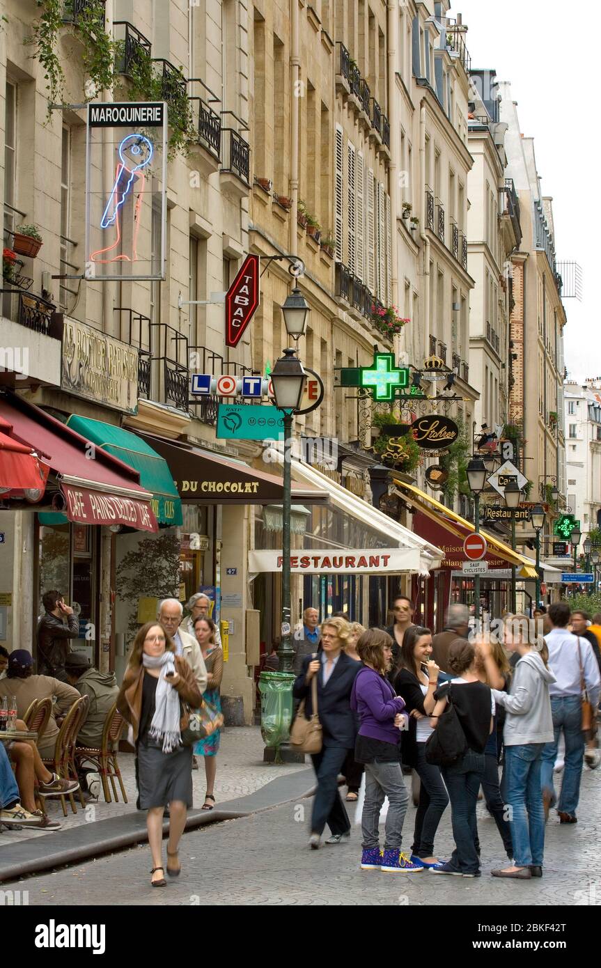 People on the street,shops, cafes and signs, Rue Montorgueil, Paris , France Stock Photo