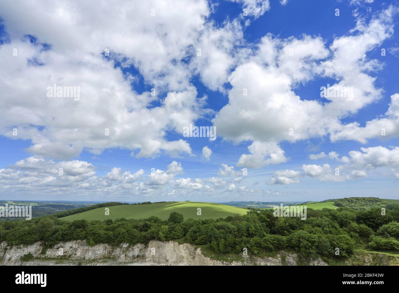 rolling hills of the south downs with puffy clouds on a summer's day Stock Photo