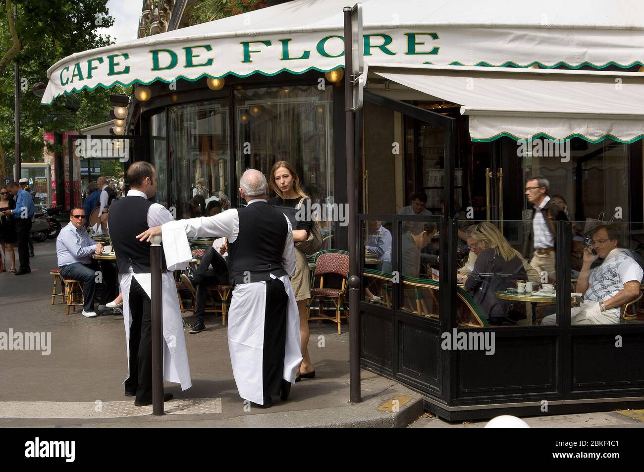 Waiters talking to a young woman and people sitting outside Cafe de Flore,  Blvd St Germain, Paris, France Stock Photo - Alamy