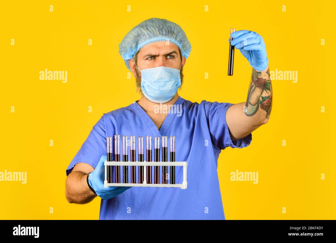 Epidemic threshold. Critical number or density of susceptible hosts. Man in medical lab inspecting samples biological material. Epidemic disease. Virus concept. Epidemic infection. Genetic analysis. Stock Photo