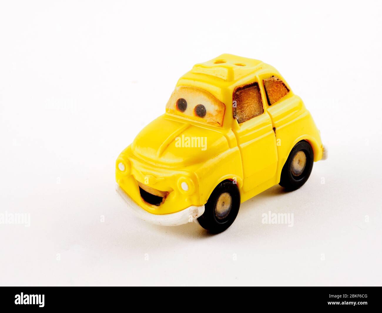 Smiling Volkswagen beetle miniature toy car Pixar Cars McDonald's Happy Meal Luigi miniature Plastic Car Stock Photo