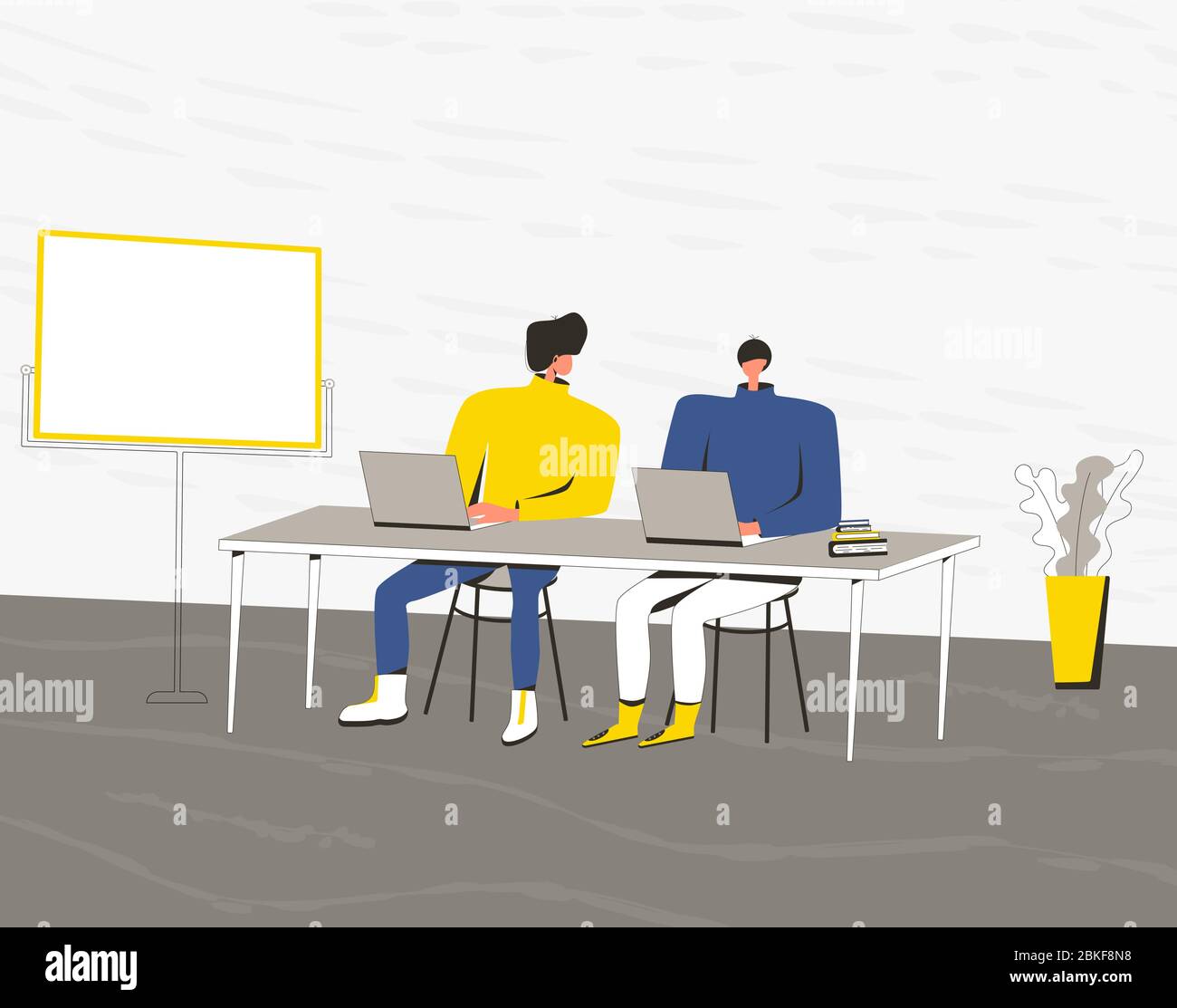 Two young men work or study together. Boys sitting at the desk and ...