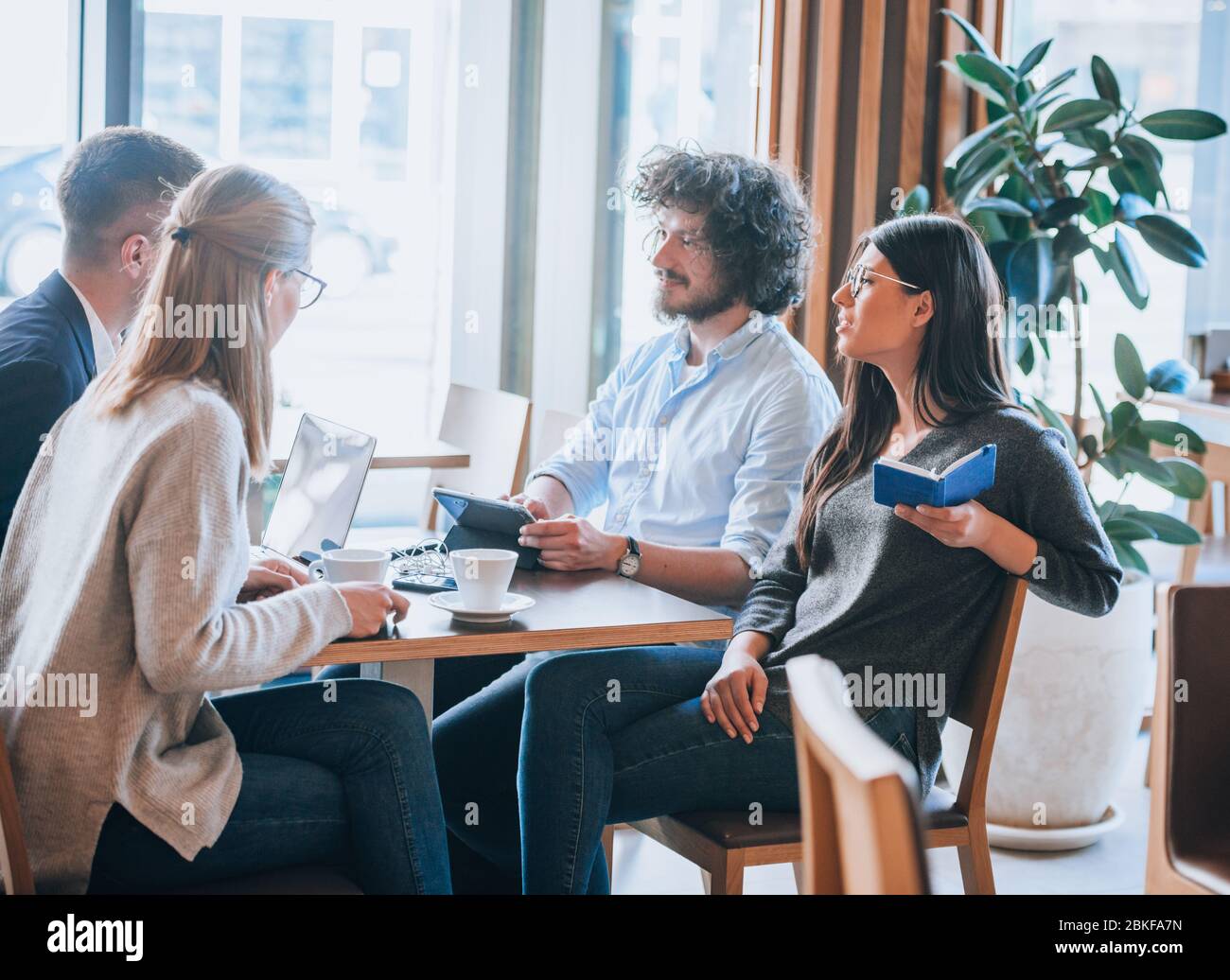 Modern business team using laptop and smartphones during a meeting ...