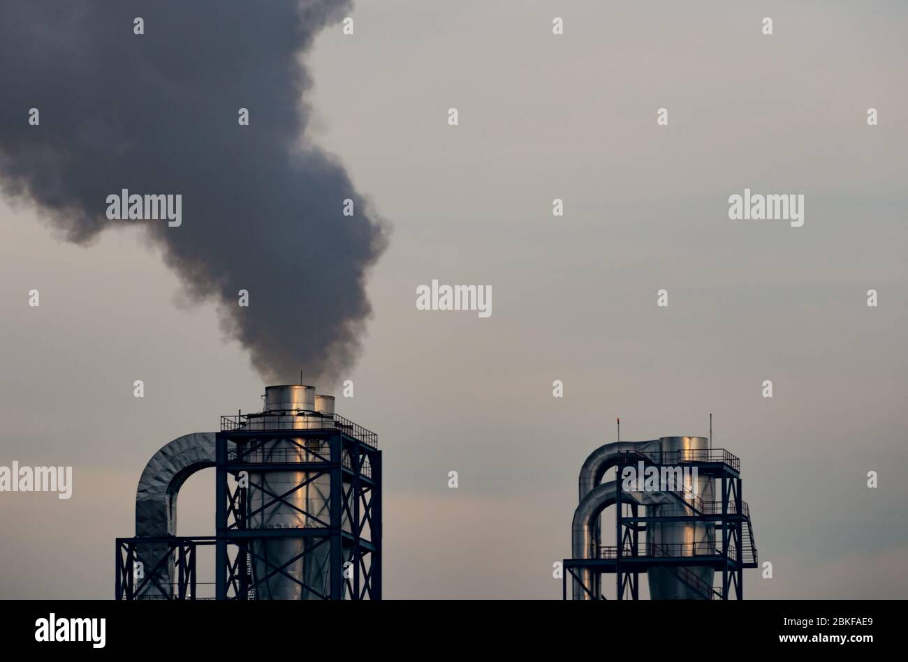 Air pollution from factory. Black smoke from chimney of industrial pipe. Global warming problem concept. Air pollutant emission factors. Air Stock Photo
