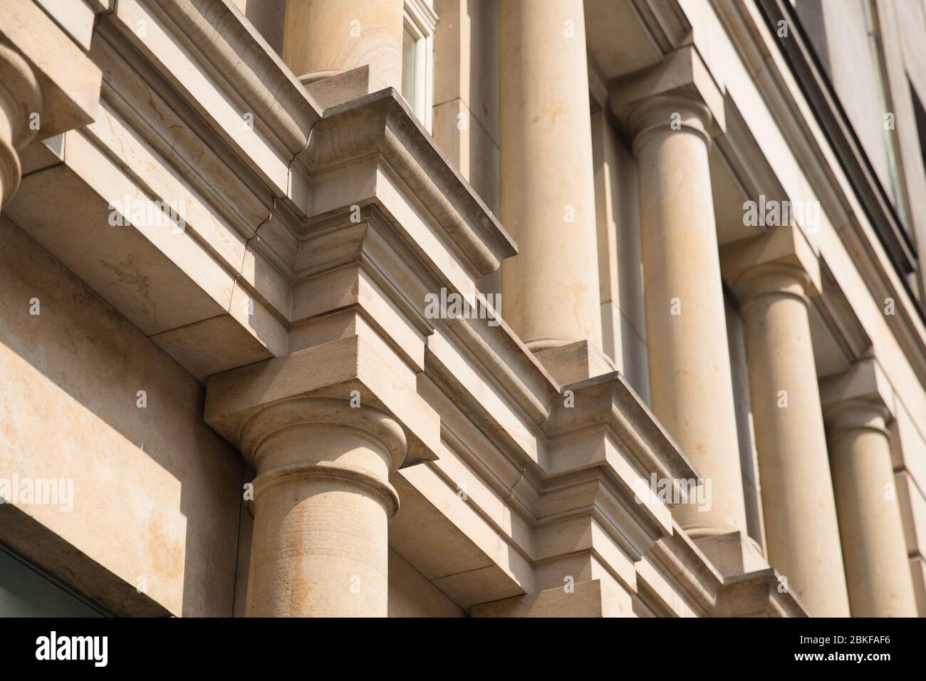 Stone columns of classical European style Doric capital close up. Play shadow and light, rhythm, meter Stock Photo