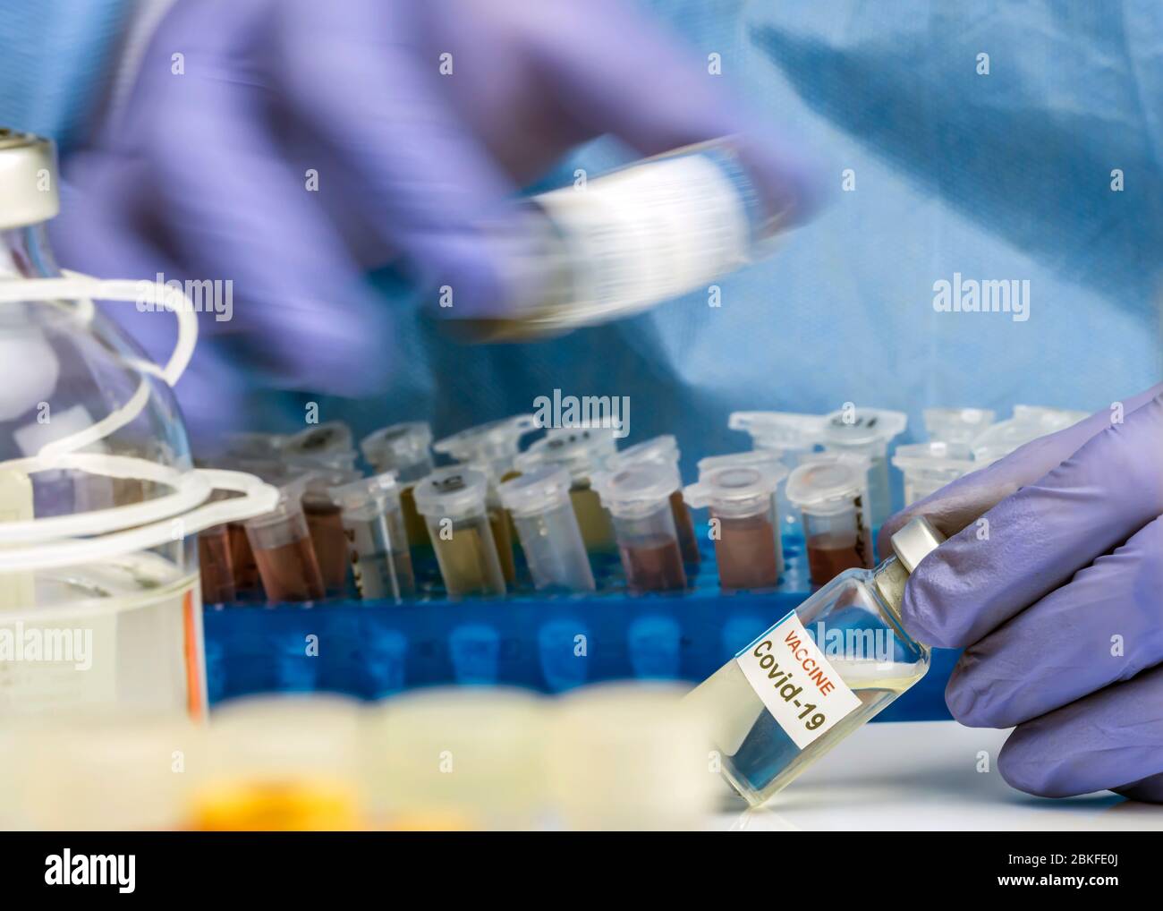 Nurse shakes vial mixing medication Coronavirus covid-19 experimental vaccine in a laboratory, conceptual image Stock Photo